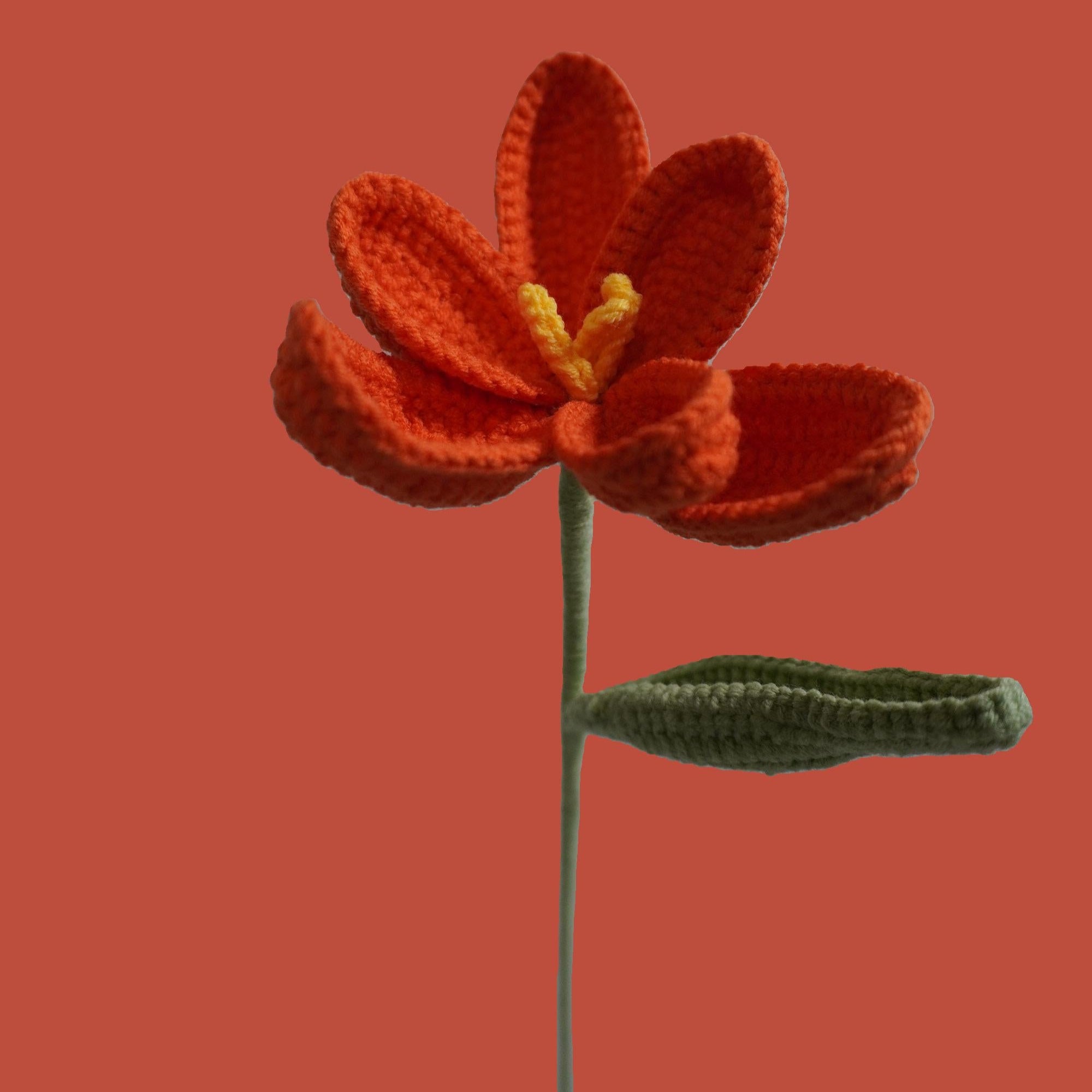 Handmade crochet tulip flower in orange yarn, eco-friendly and perfect for sustainable home decor or gifting
