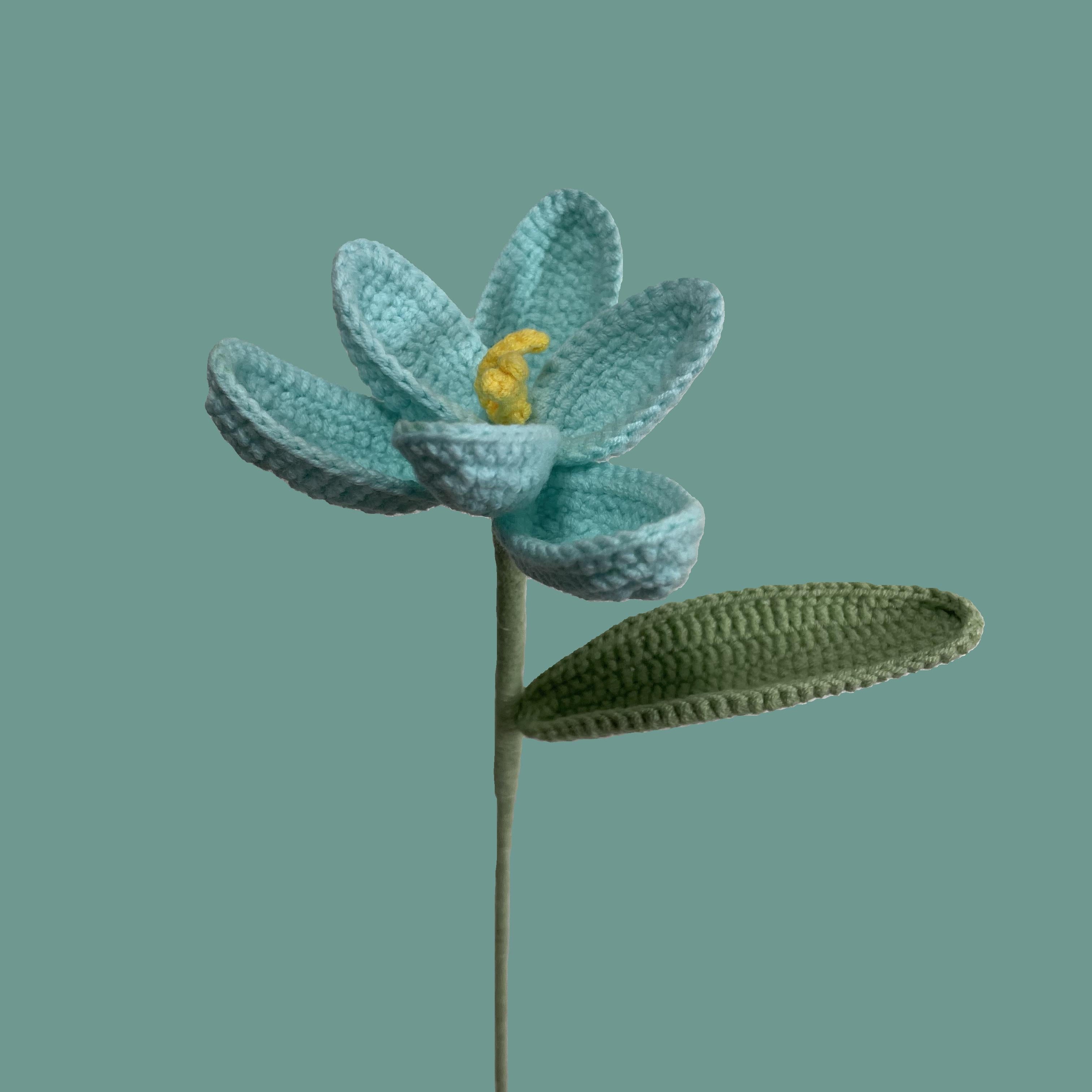 Handmade crochet tulip flower in pale turquoise yarn, eco-friendly and perfect for sustainable home decor or gifting
