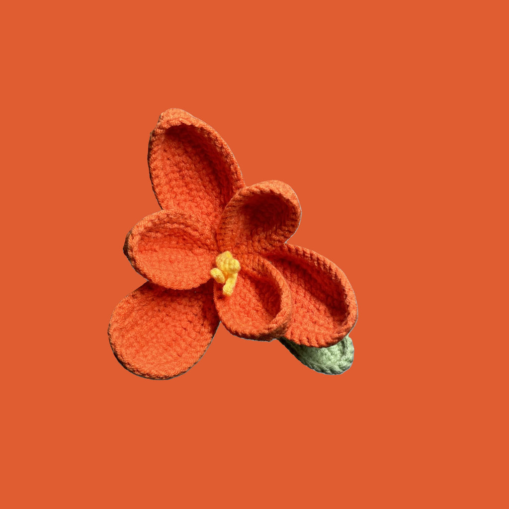 Handmade crochet tulip flower in coral yarn, eco-friendly and perfect for sustainable home decor or gifting
