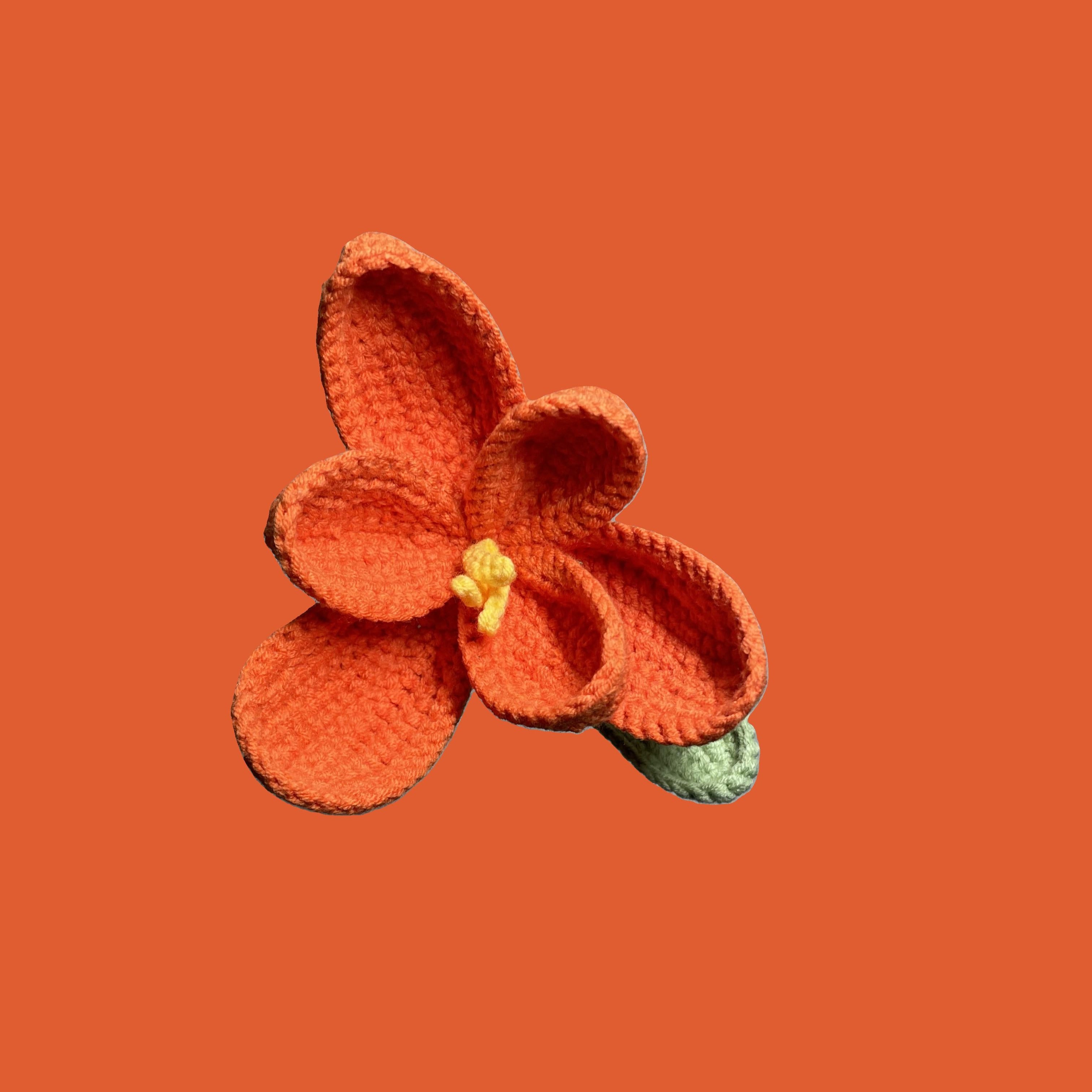 Handmade crochet tulip flower in coral yarn, eco-friendly and perfect for sustainable home decor or gifting
