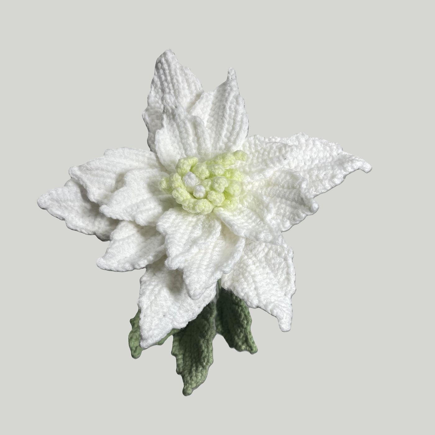 Handmade crochet Chinese rose flower in white yarn with green leaves for sustainable home decor and gifts
