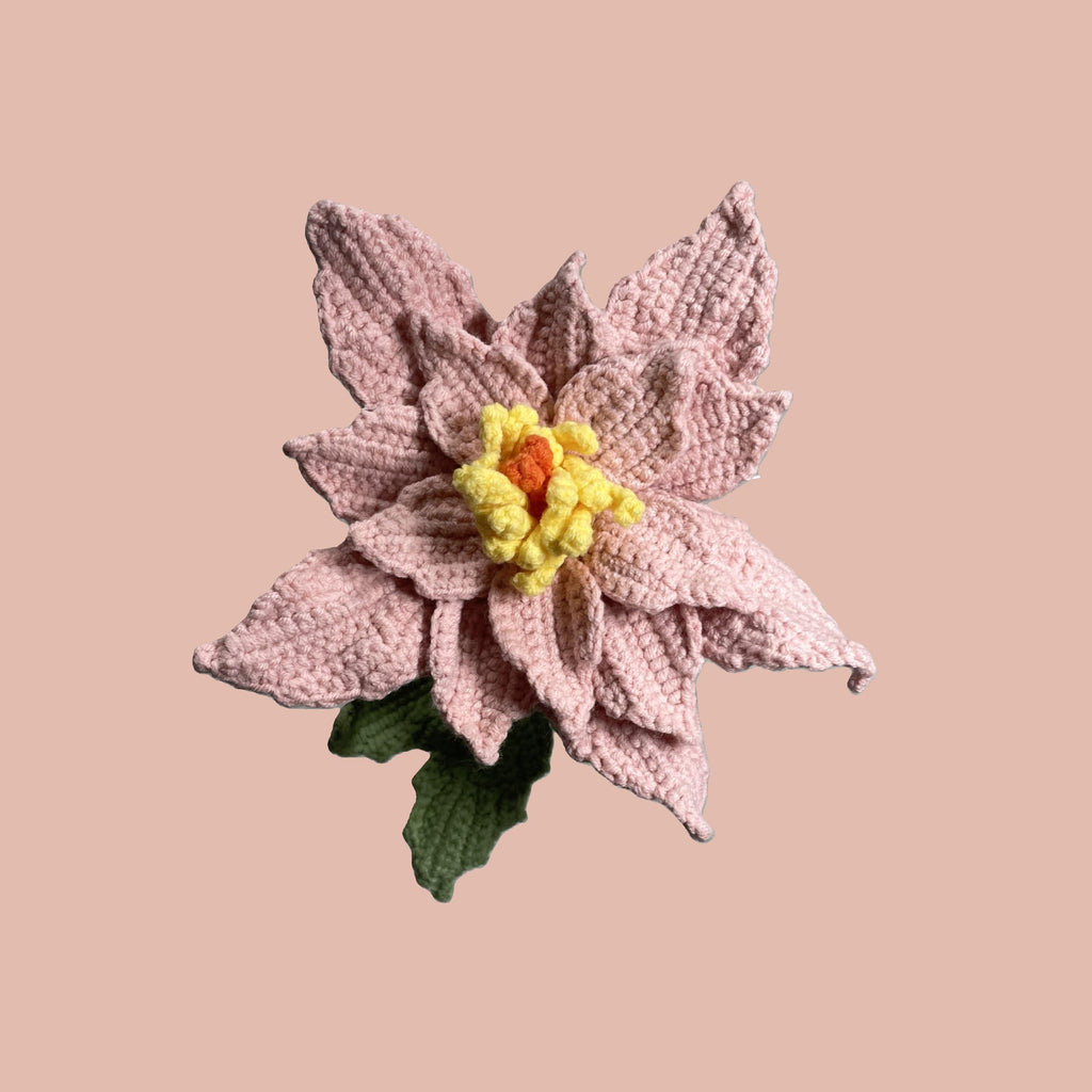 Handmade crochet Chinese rose flower in pink yarn with green leaves for sustainable home decor and gifts
