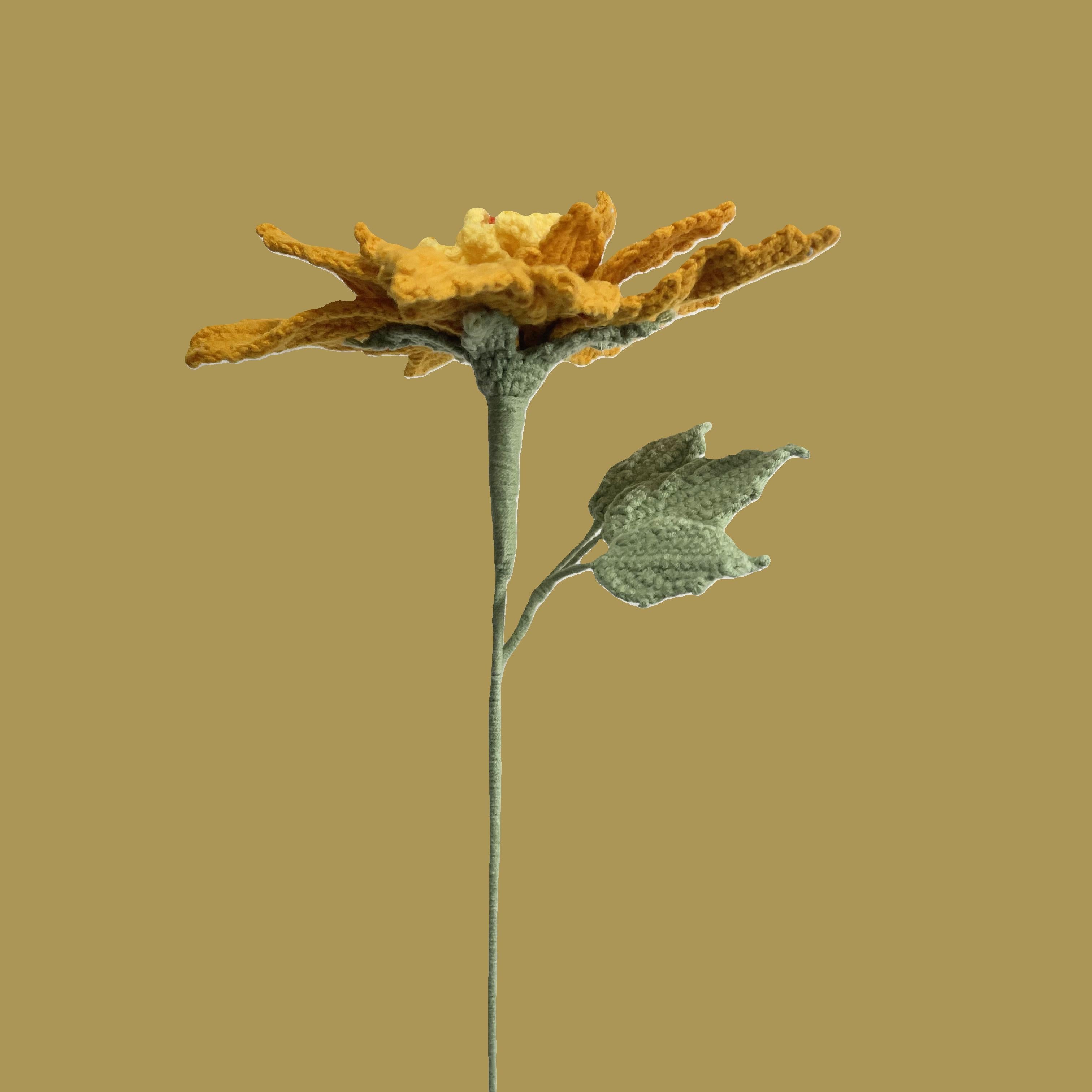 Handmade crochet Chinese rose flower in gold yarn with green leaves for sustainable home decor and gifts
