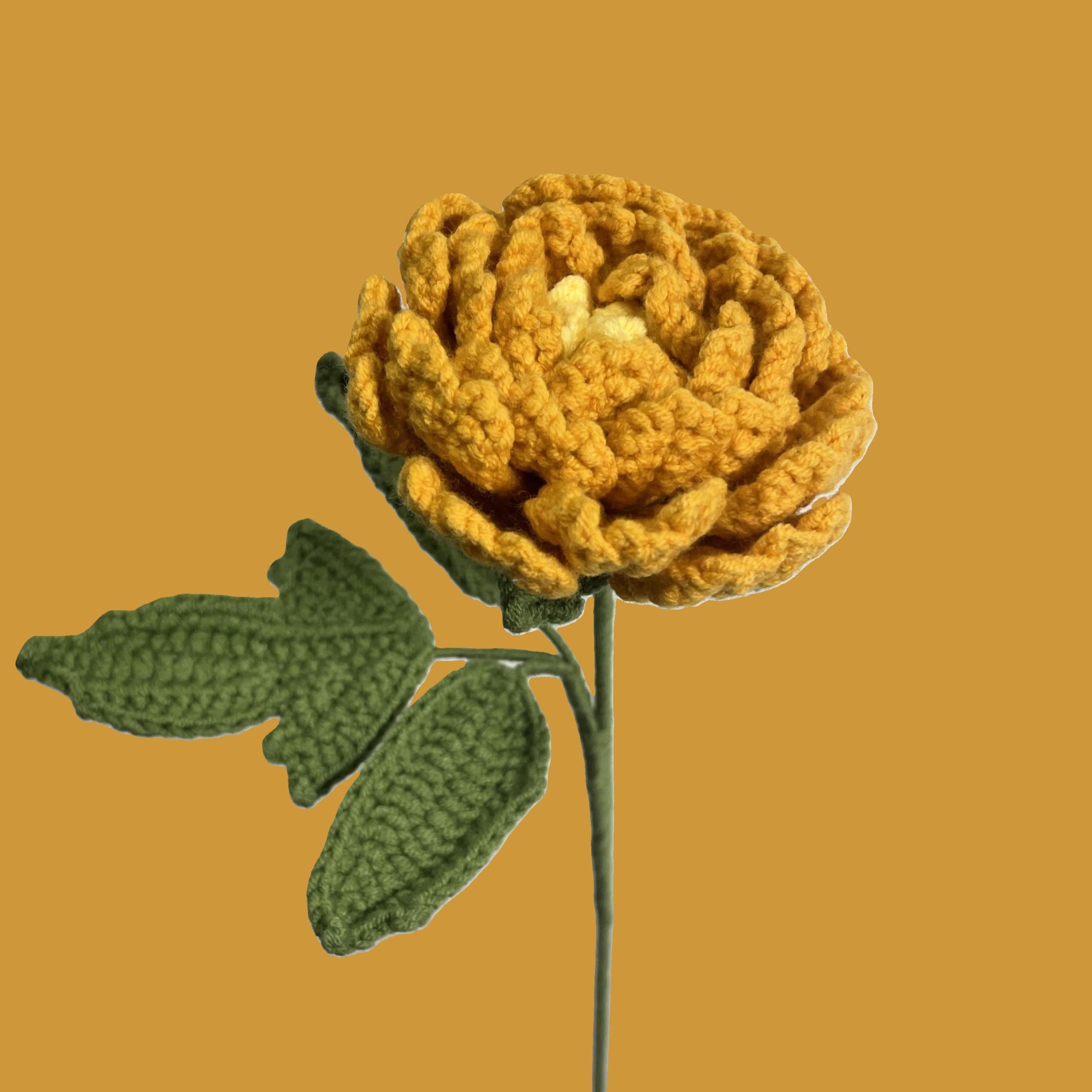 Yellow handmade crochet peony flower on pastel background – sustainable gift
