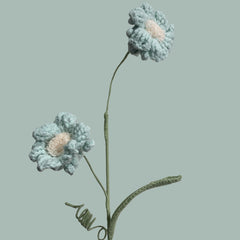 Handmade crochet daffodil flower in light sky blue yarn, perfect for eco-friendly home decor and gifting
